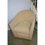 An oatmeal coloured tub chair