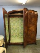 An Art Deco walnut three door wardrobe