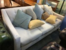 A cream three seater settee