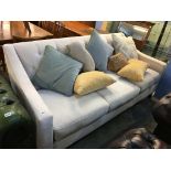 A cream three seater settee