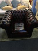 An oxblood Chesterfield club armchair