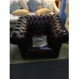 An oxblood Chesterfield club armchair