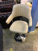 A cream leather swivel bar stool