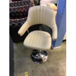 A cream leather swivel bar stool