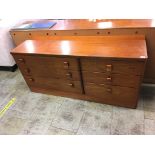 A teak chest of drawers