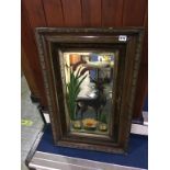 A bevel edged wall mirror, the wooden frame with a painted deer in waterside scene