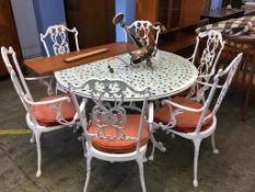 A large metalwork garden table and six chairs