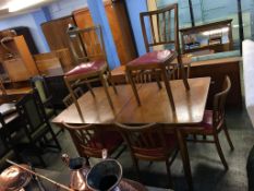 A teak dining room suite to include; sideboard, table and eight chairs