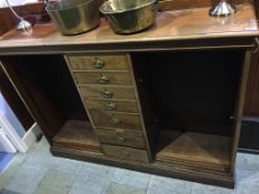 A mahogany bookcase with seven central drawers, flanked by two open bookcase shelves, 154cm wide