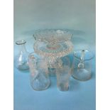 A selection of cut and etched glassware, three tier cake stand, two jugs and a cup and a vase