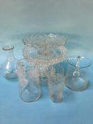 A selection of cut and etched glassware, three tier cake stand, two jugs and a cup and a vase