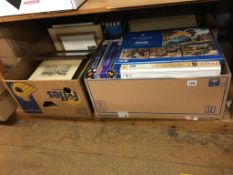 A shelf of jigsaw puzzles, books and framed prints (local interest)