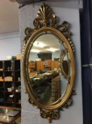 Two oval wall hanging mirrors