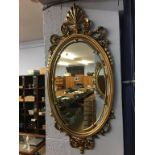 Two oval wall hanging mirrors