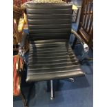 A Charles Eames style chrome office chair