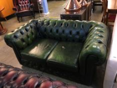 A green Chesterfield leather two seater settee