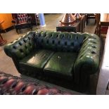 A green Chesterfield leather two seater settee