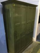 A green painted school cupboard, with fitted shelves, 132cm wide