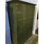 A green painted school cupboard, with fitted shelves, 132cm wide