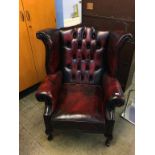 An oxblood Chesterfield leather high back armchair