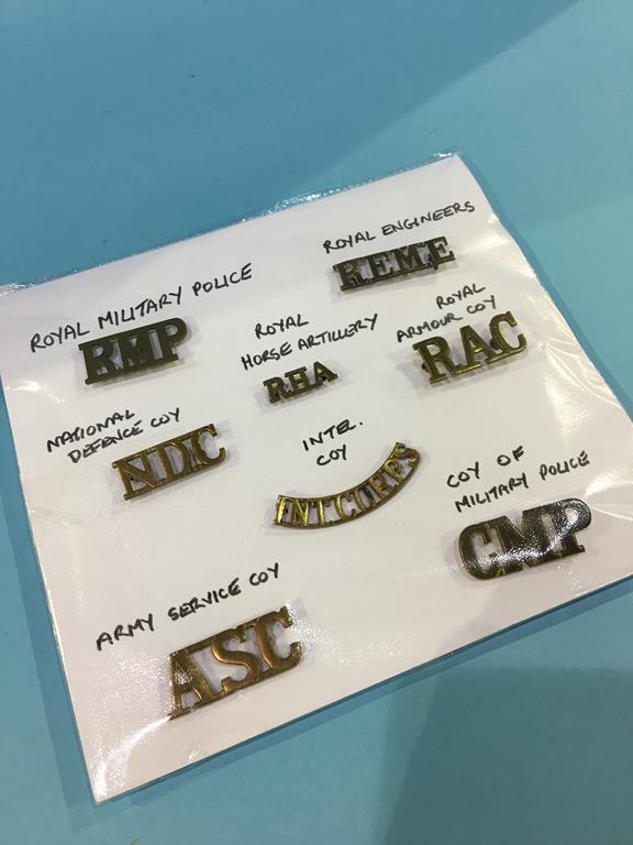Eight military cap badges