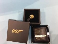 A boxed presentation 007 gold coin, weight 7.777 grams