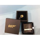 A boxed presentation 007 gold coin, weight 7.777 grams