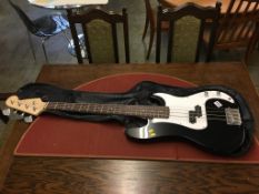 An unmarked four string electric bass guitar