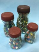 Collection of marbles in four jars