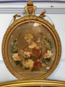 A 19th century oval tapestry of a young girl sewing and an oval gilt frame, 61 x 51cm