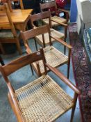 A set of four teak carver chairs