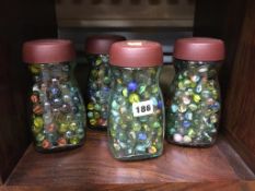 Collection of marbles in four jars