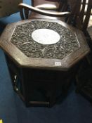 A Middle Eastern octagonal carved and brass inlaid occasional table, 60cm wide