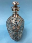 A Dimple Whiskey decanter, overlaid with Oriental silver, 23cm high
