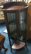 An Edwardian mahogany standing corner cabinet with lead glass door