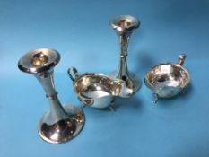 Pair of silver sauce boats (299g) and a pair of weighted silver candlesticks