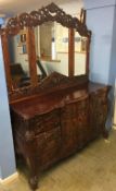 A large reproduction carved mahogany chest of drawers, with triple mirror to the back, a carved