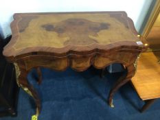 A reproduction walnut fold over games and card table with gilt metal mounts, 82cm wide