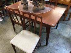 A teak Youngers draw leaf table and a set of four chairs