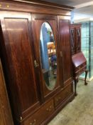 Edwardian mahogany mirror door wardrobe and an oak hall wardrobe