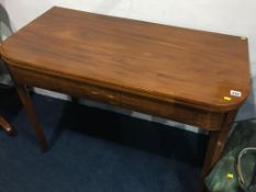 A 19th century mahogany fold over tea table