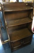 An Ercol graduating bookcase, 61cm wide