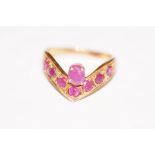 18ct gold "Wish bone" ring set with seven pink sto