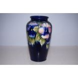 William Moorcroft pansy pattern vase. Height 22 cm