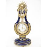 A blue porcelain lyre shaped mantle clock, the mov