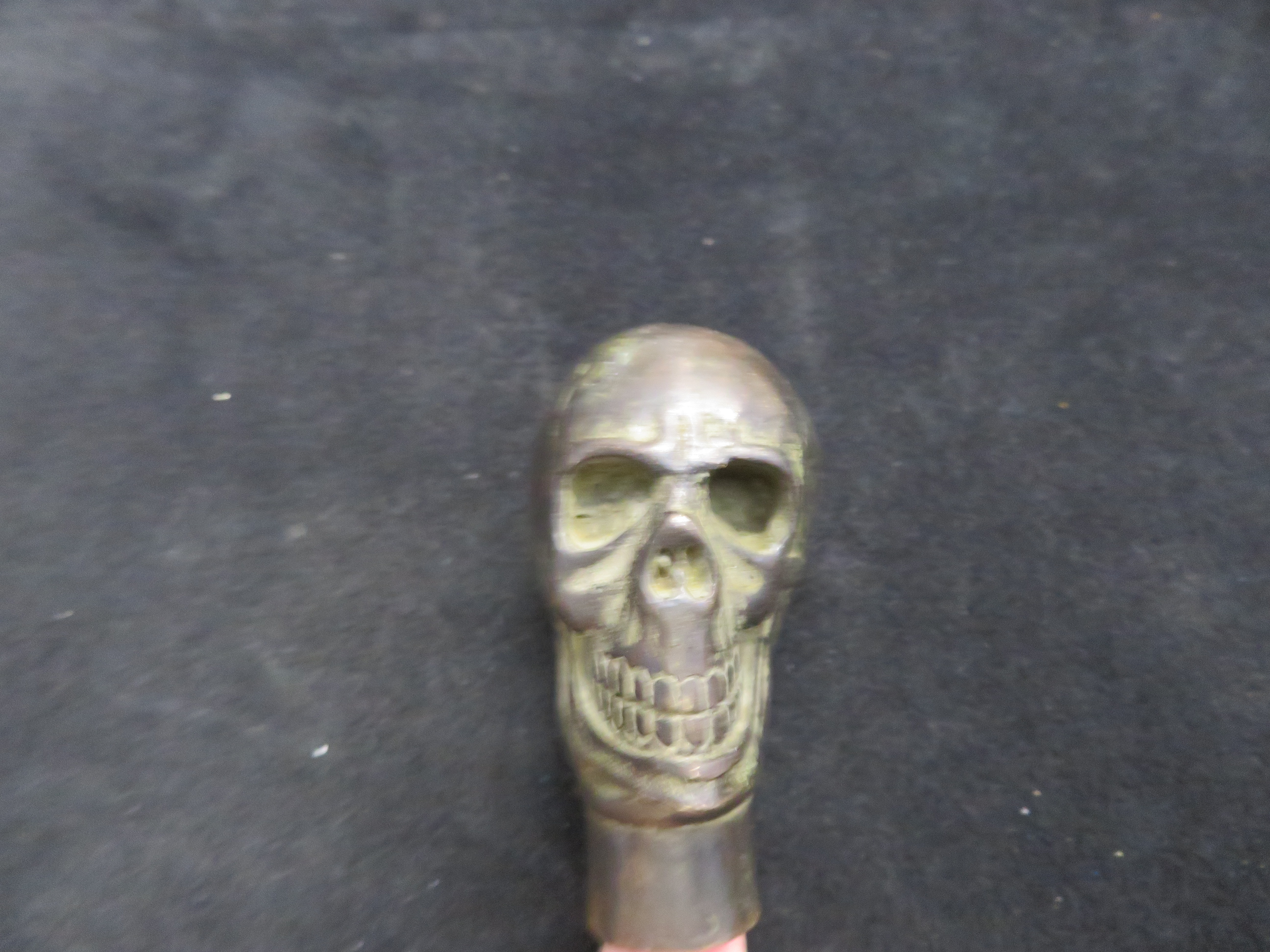 Metal walking stick handle in the form of a skull