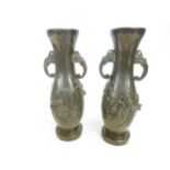 Pair of bronze vases with elephant handles Height