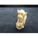 Ivory netsuke model of a thinking monkey