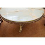 Heavy onyx coffee table with brass under carriage