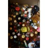 Box of miniature alcohol bottles, all full